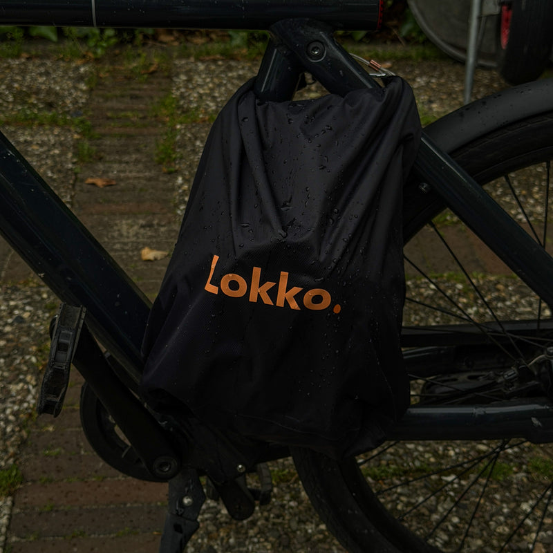 Water-resistant Lokko bag locked to a bike frame in the rain